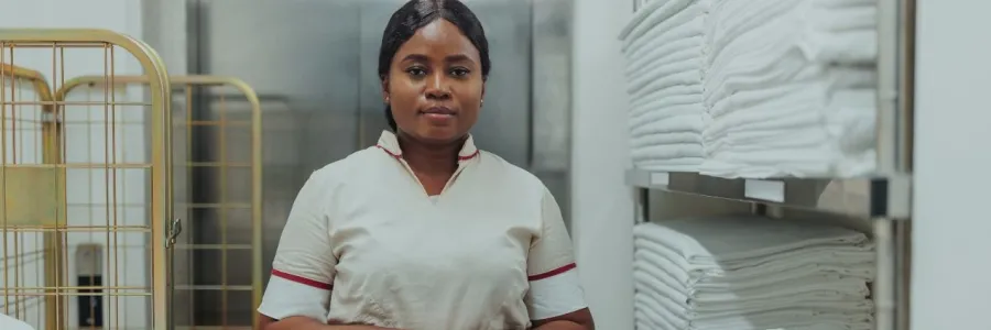 A hotel worker in a linen closet