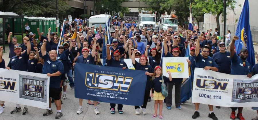 Crowd of Steelworkers marching with raised fists